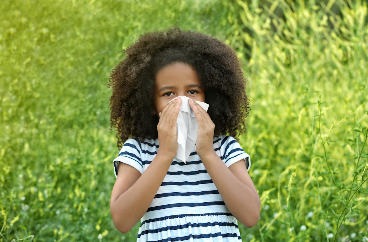 Young Girl Blowing Nose from Seasonal Allergies