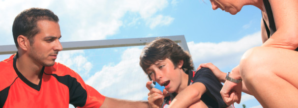 Young Soccer Player with Asthma Using Inhaler